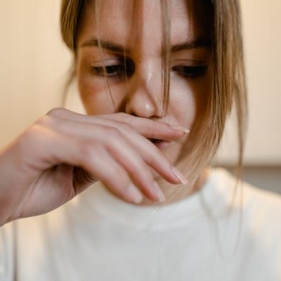 a woman smelling something bad
